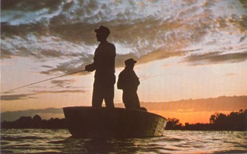 Featured is a postcard image of two fishermen enjoying fishing by sunset on the Ohio River.  The original postcard is for sale in The unltd.com Store.